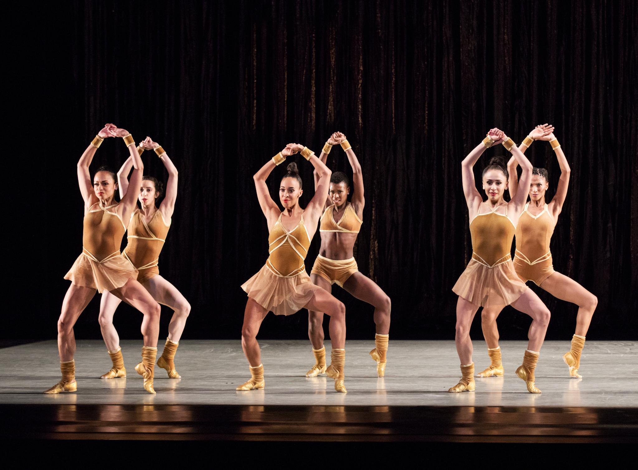 Female dancers holding their hand together in the air