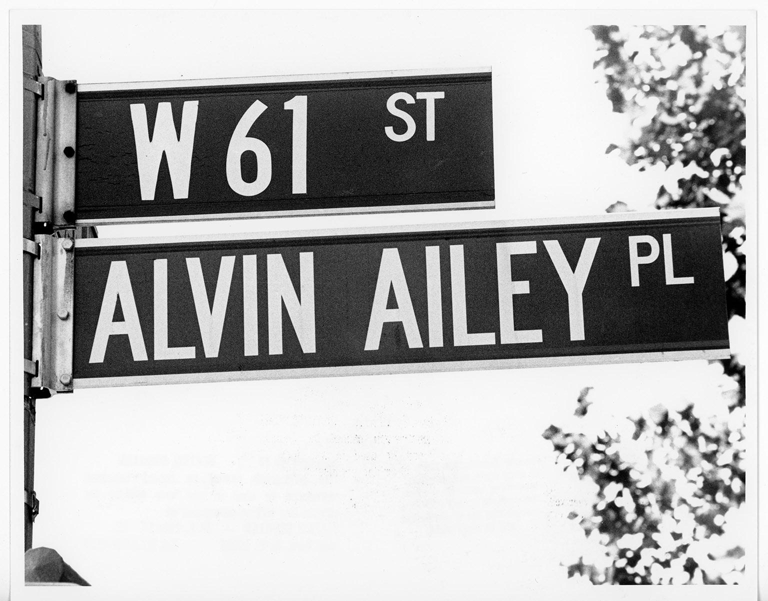 A photo of two street signs. The top says W 61ST and the bottom says ALVIN AILEY PL