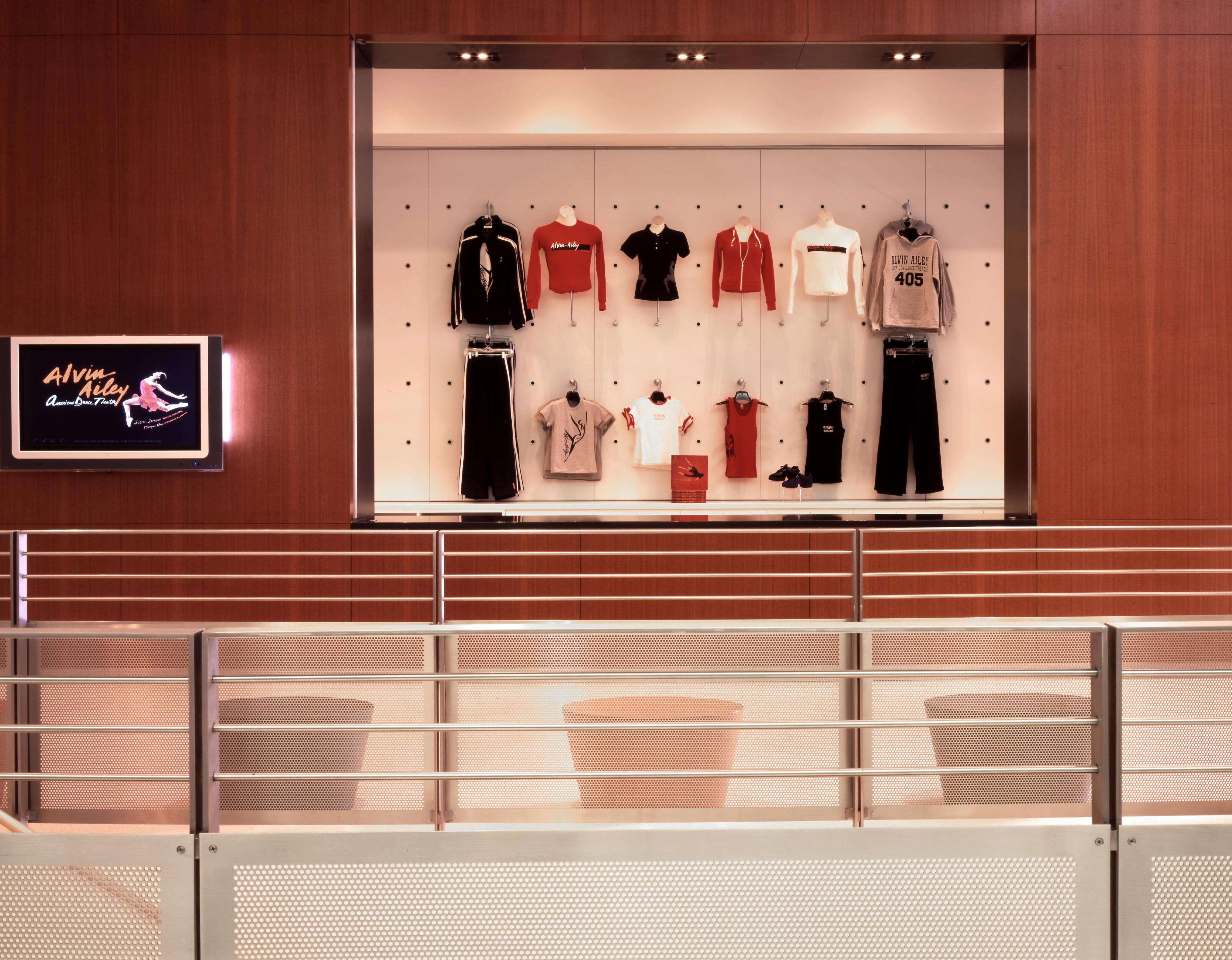 Dancewear hangs behind a glass screen in the lobby of a building.