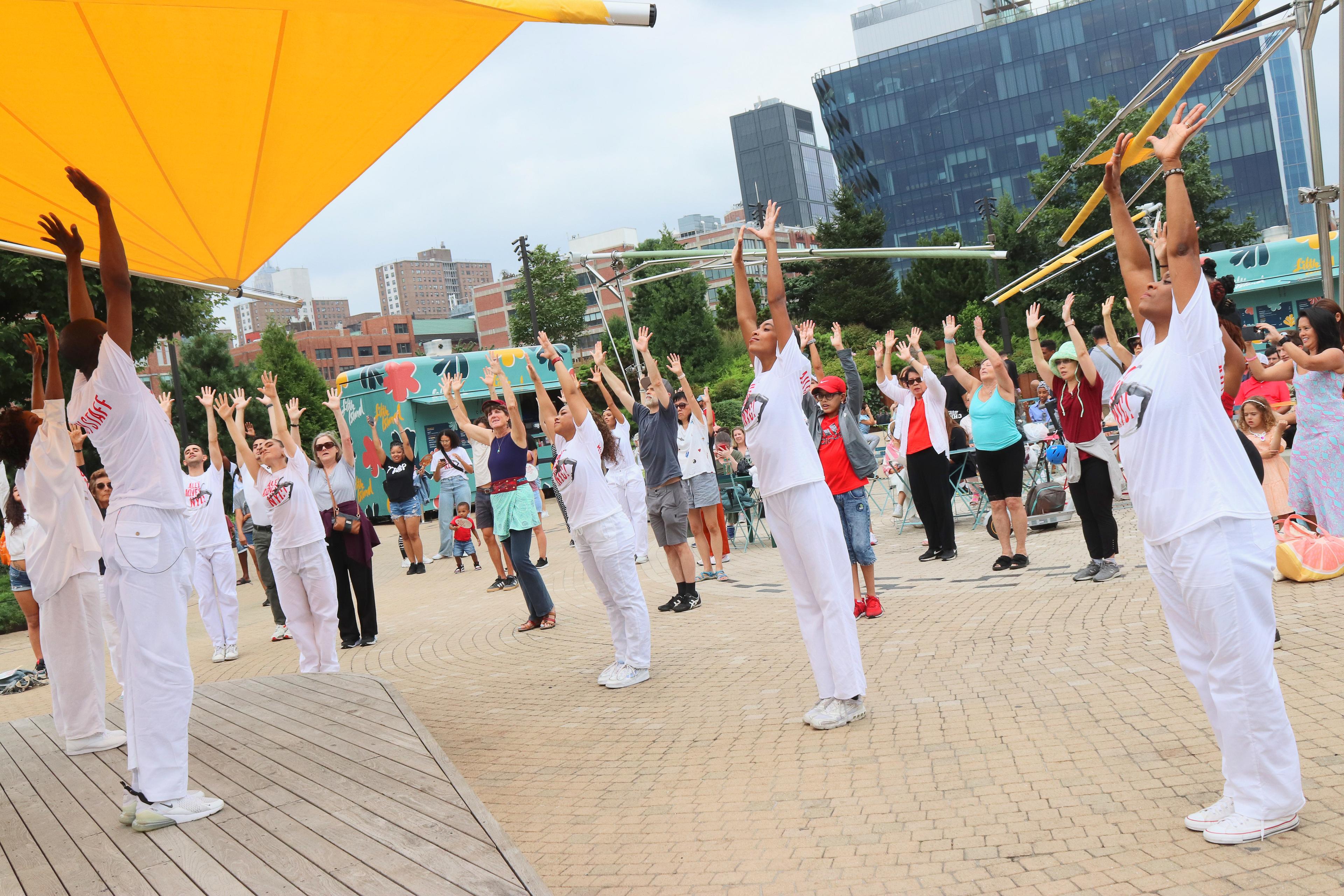 Ailey members stretching on Little Island