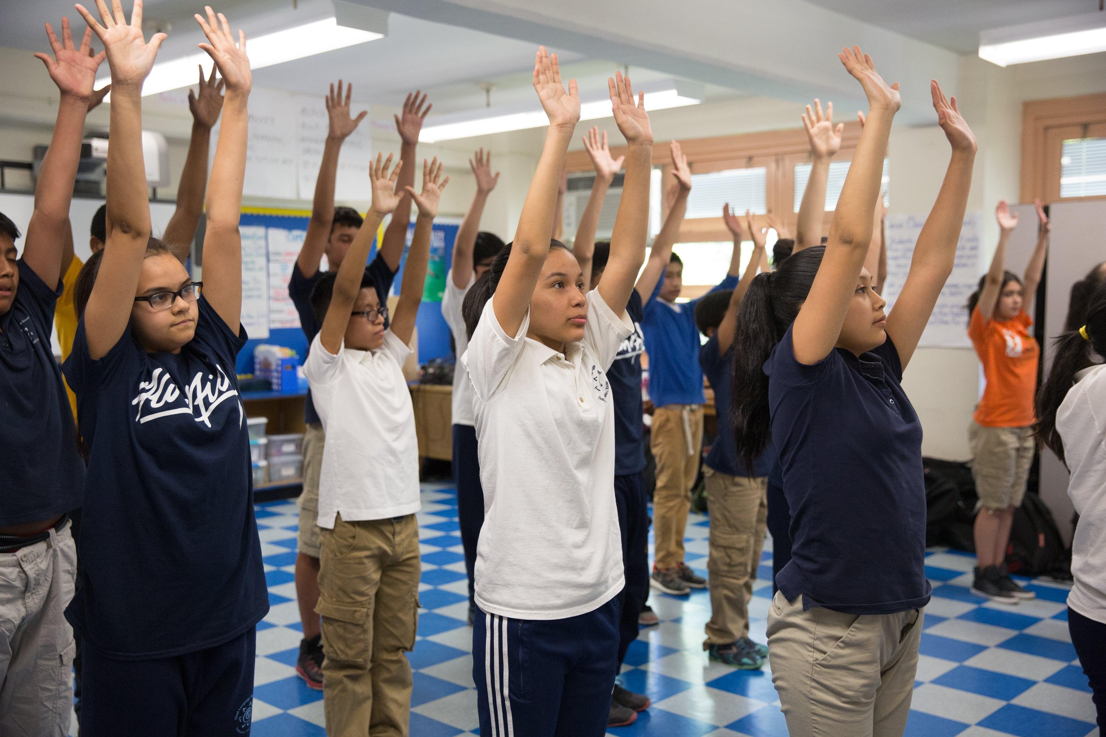 Ailey Dance Kids raising their arms