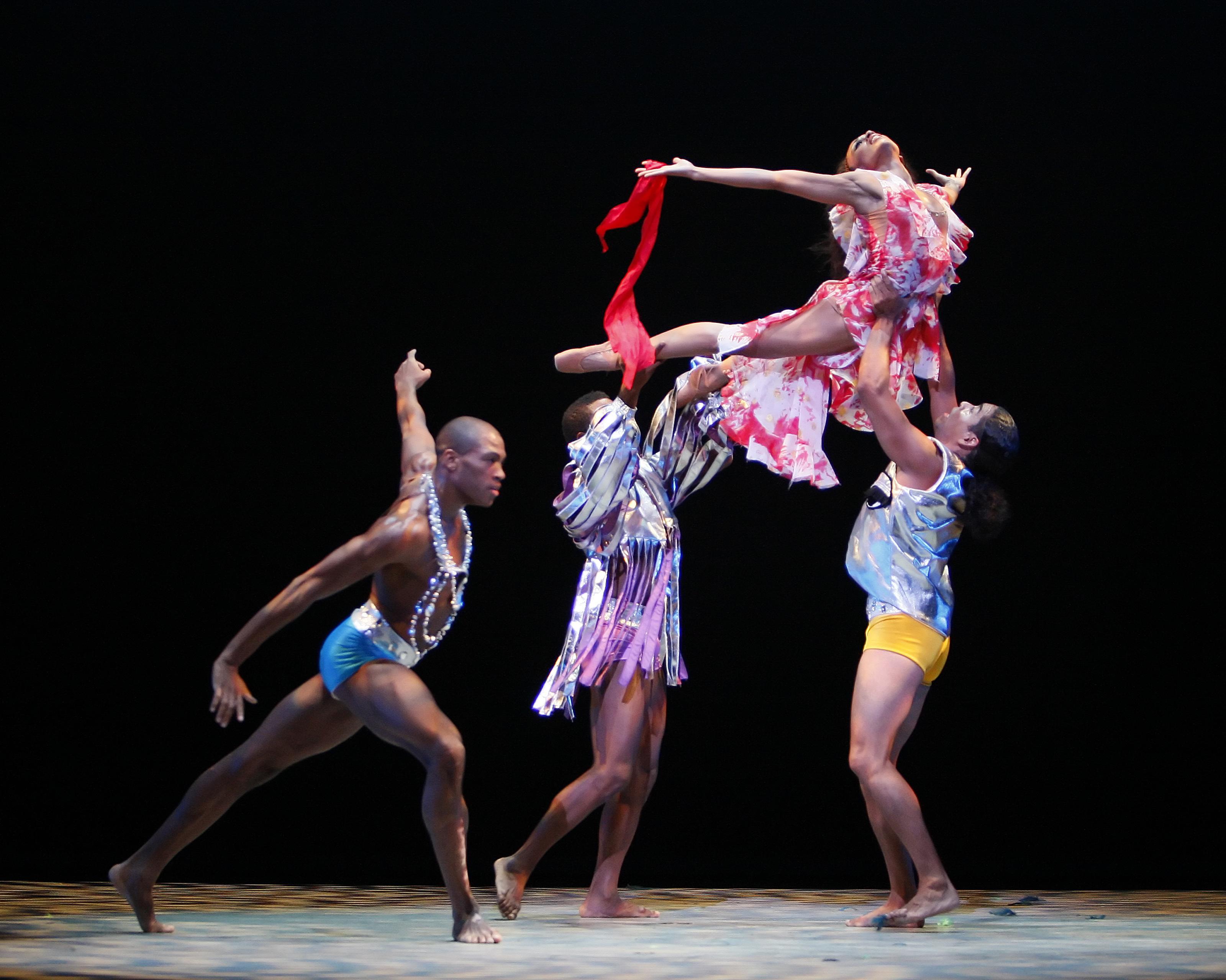 Woman being held up by two men 