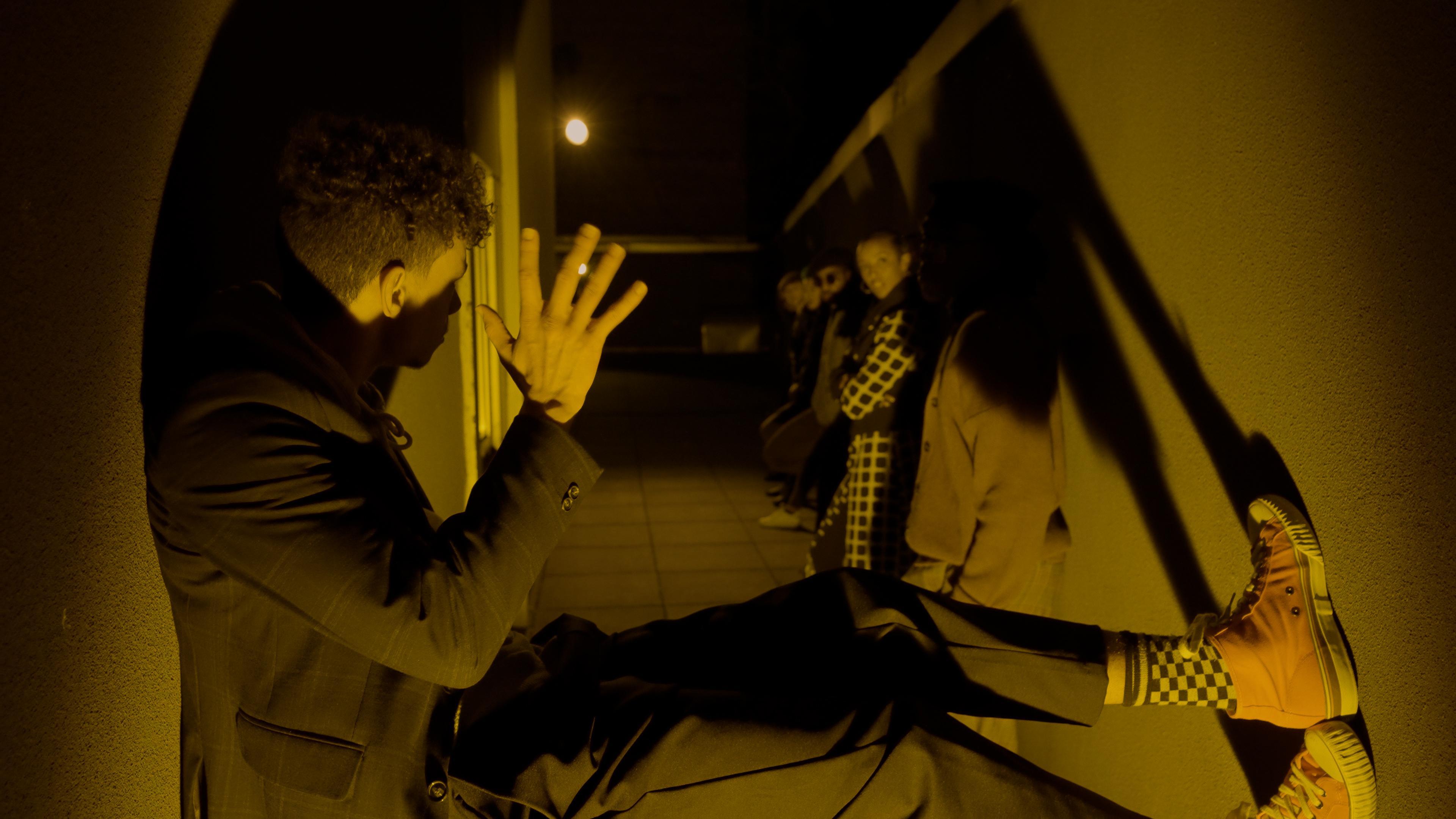 Man sitting on the ground waving at a woman