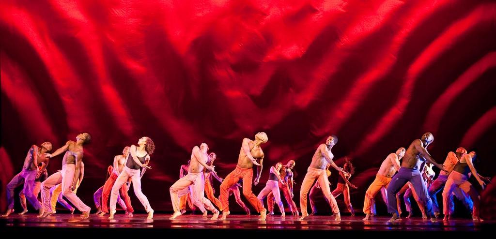 Group of dancers with heads tilted up