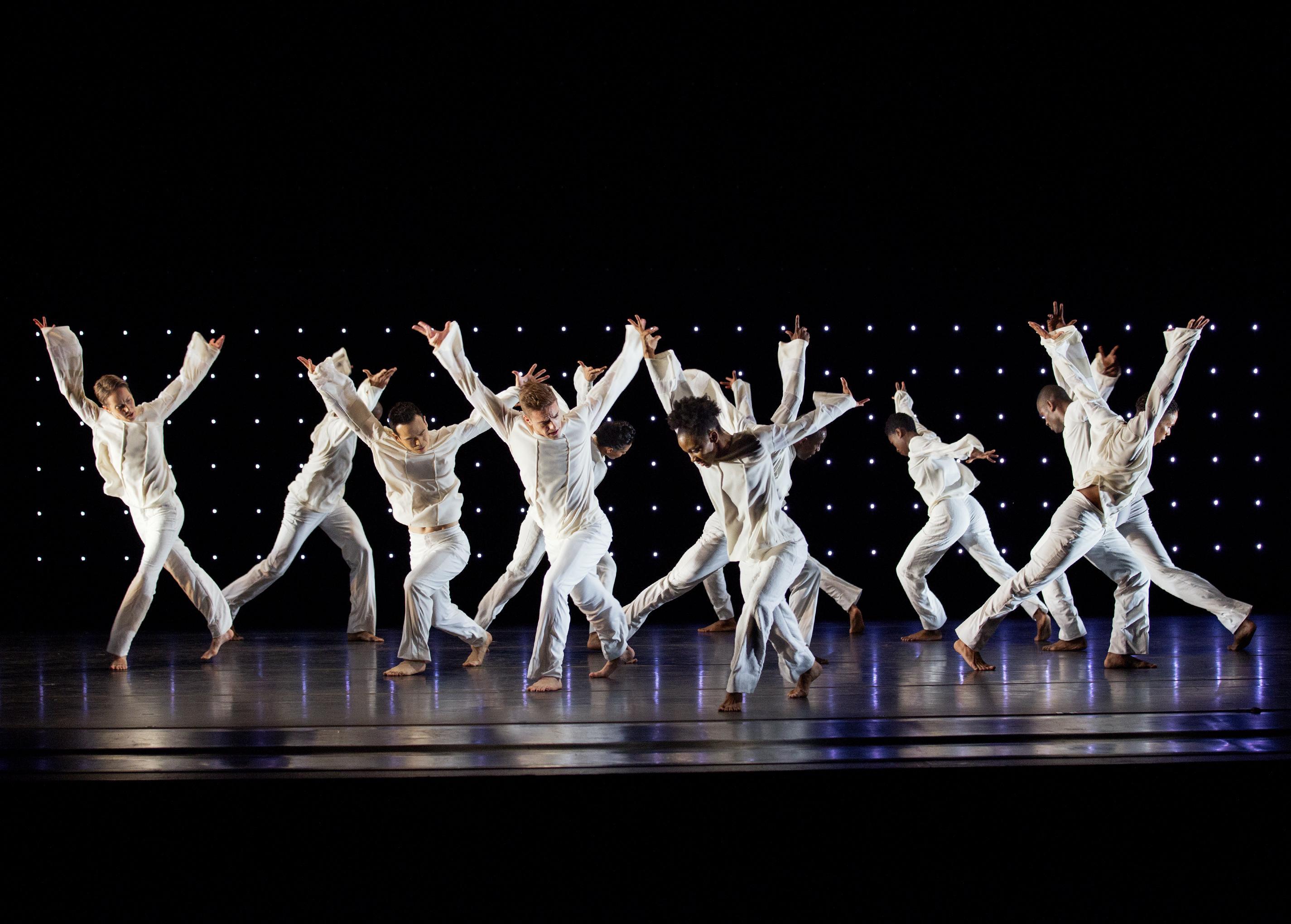 Group of dancers leaping in the air with arms outstretched