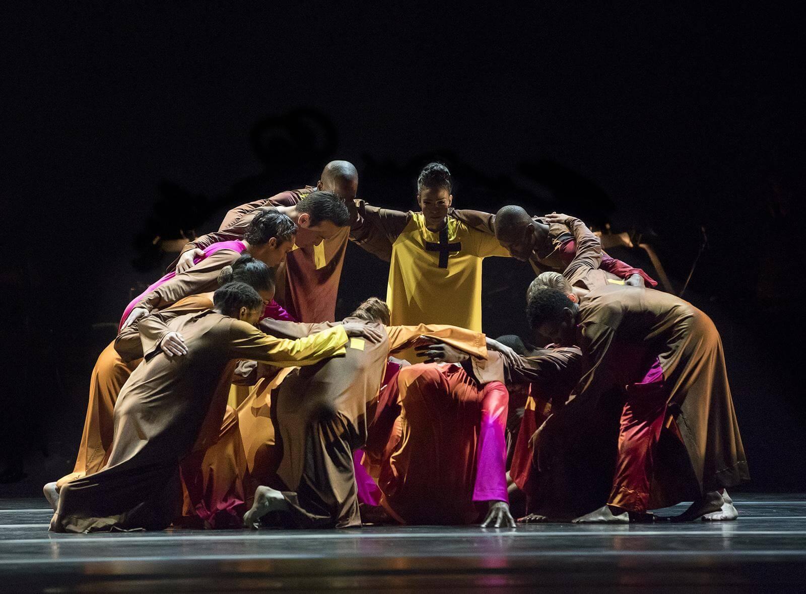 Photo of Performers huddled together in Mass