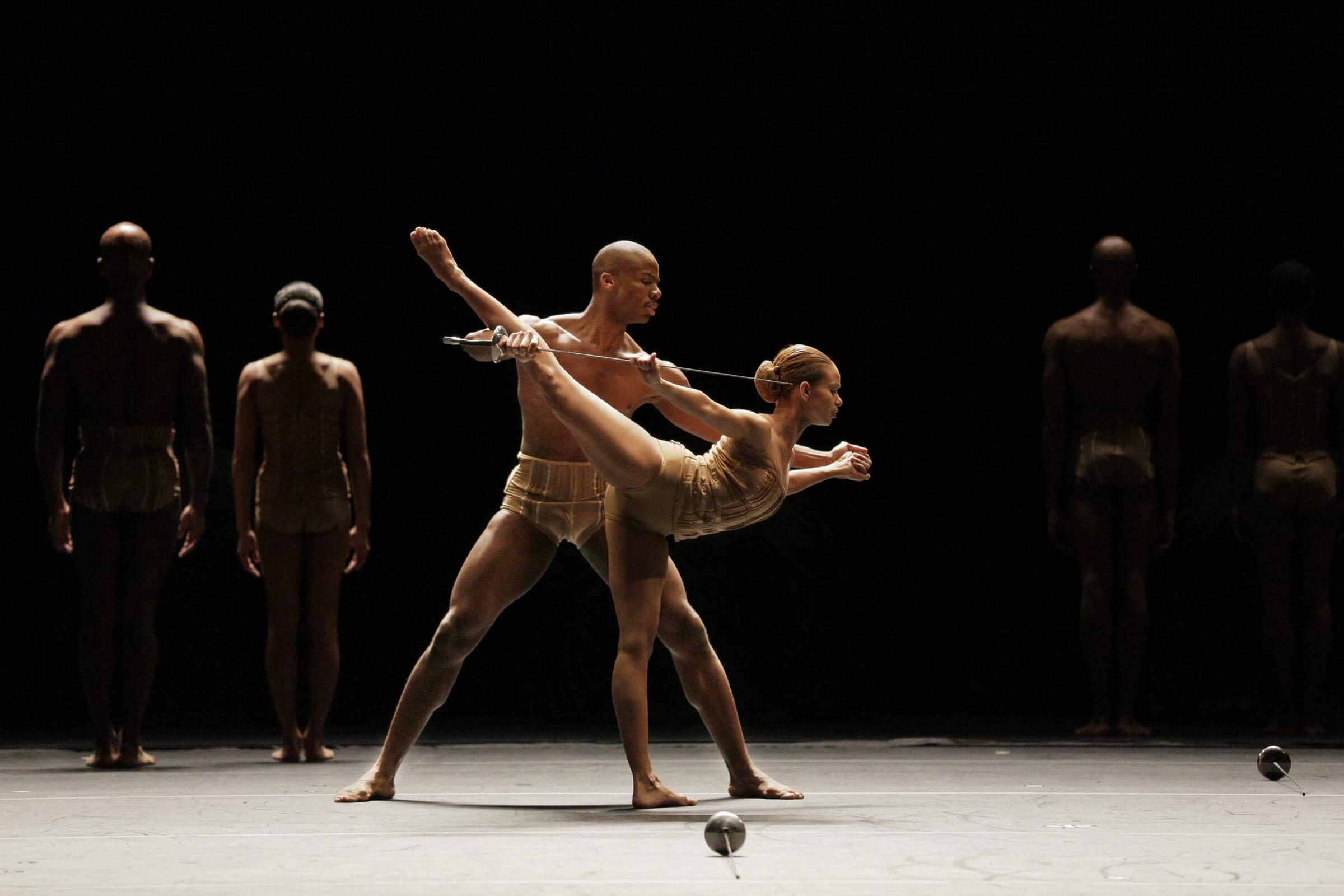 Photo of two dancers with fencing swords in Petite Mort