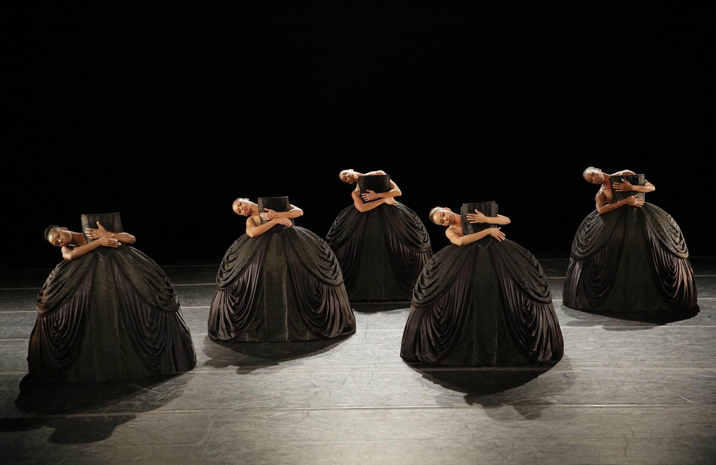 Photo of 5 dancers holding the bottom of dresses in Petite Mort