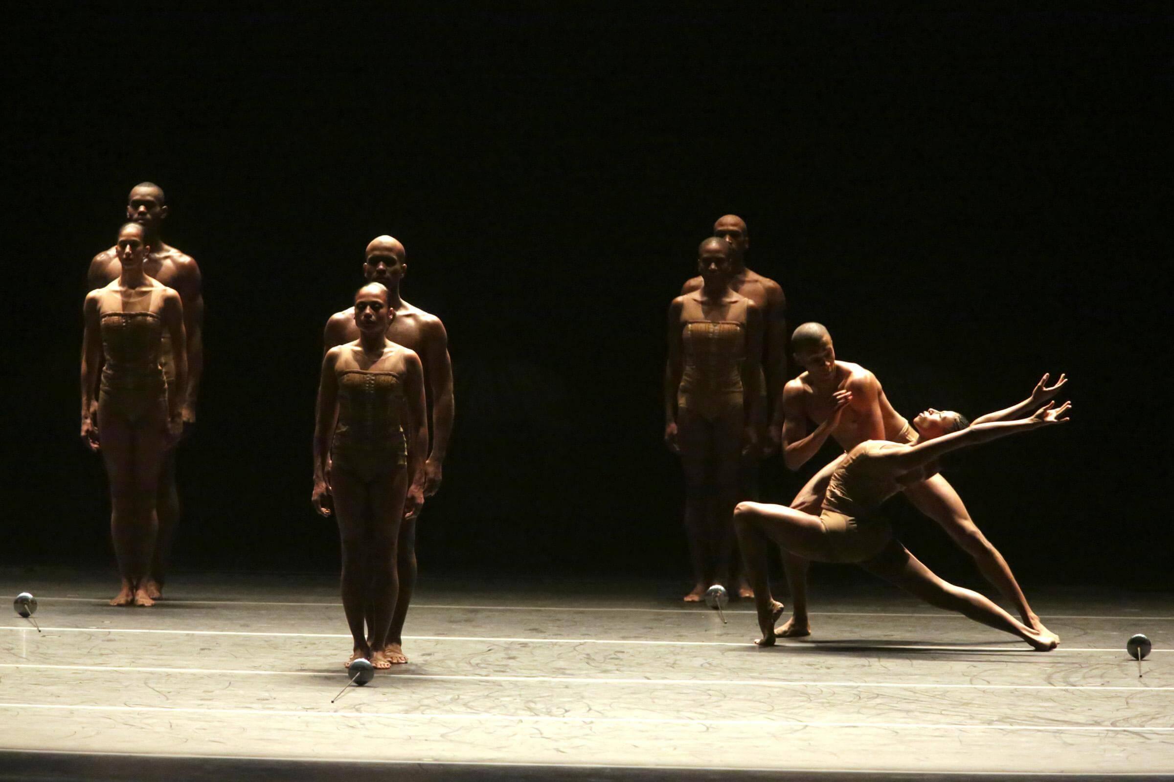 photo of a dancer striding forward while the others remain still