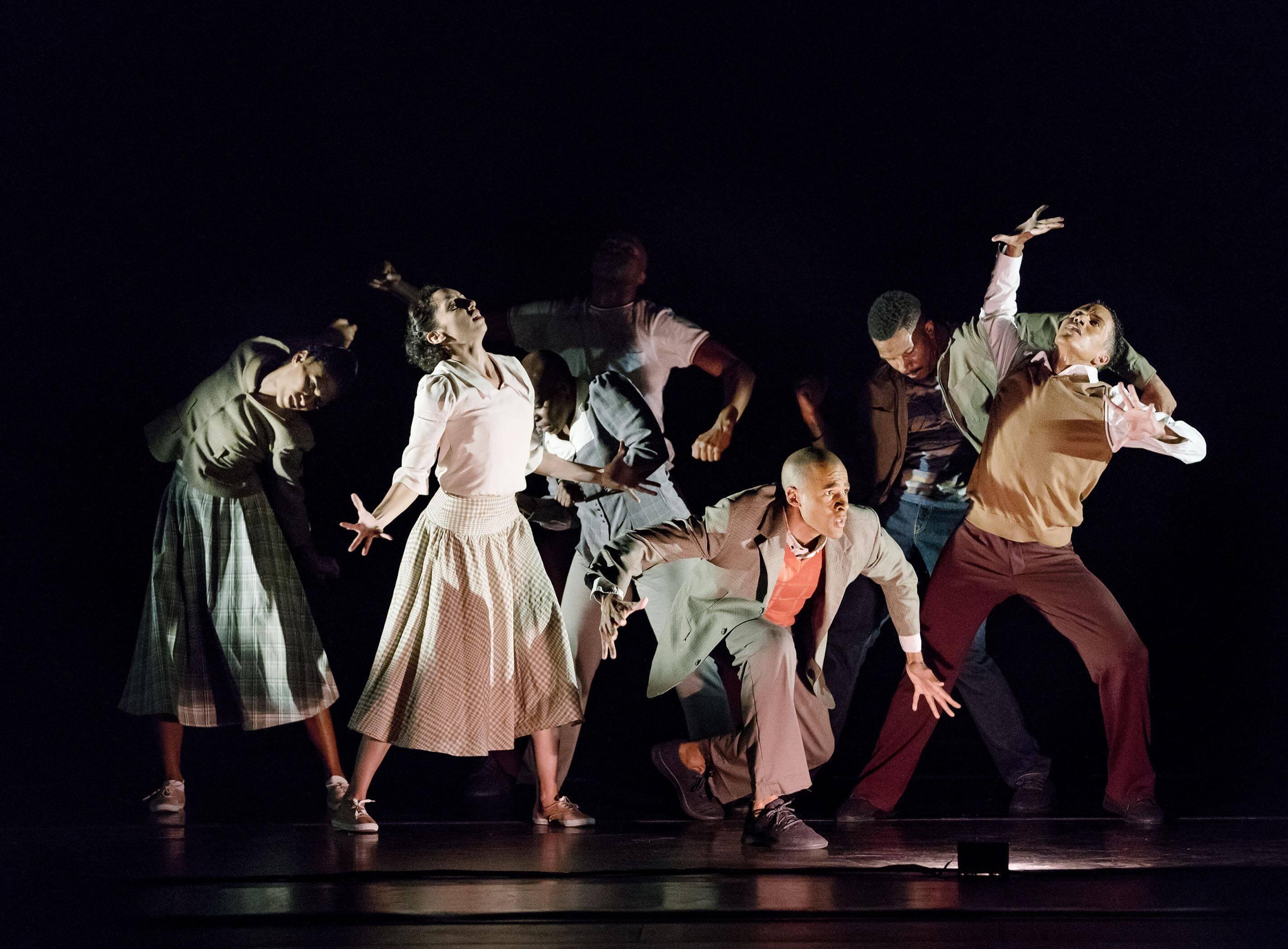 All of the dancers striking a pose while the light shines on them dramatically