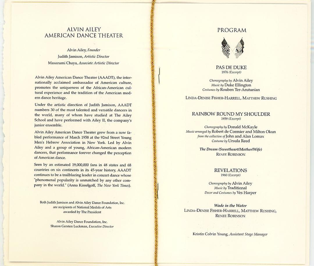 Program for Alvin Ailey American Dance Theater performance. Left page details history and significance of the company, with credits to Alvin Ailey, Judith Jamison, and Masazumi Chaya. Right page lists the program: Pas de Duke, Rainbow Round My Shoulder, Revelations, and Wade in the Water. Performers include Linda-Denise Fisher-Harrell, Matthew Rushing, and Renee Robinson. Gold tassel attached at the bottom.