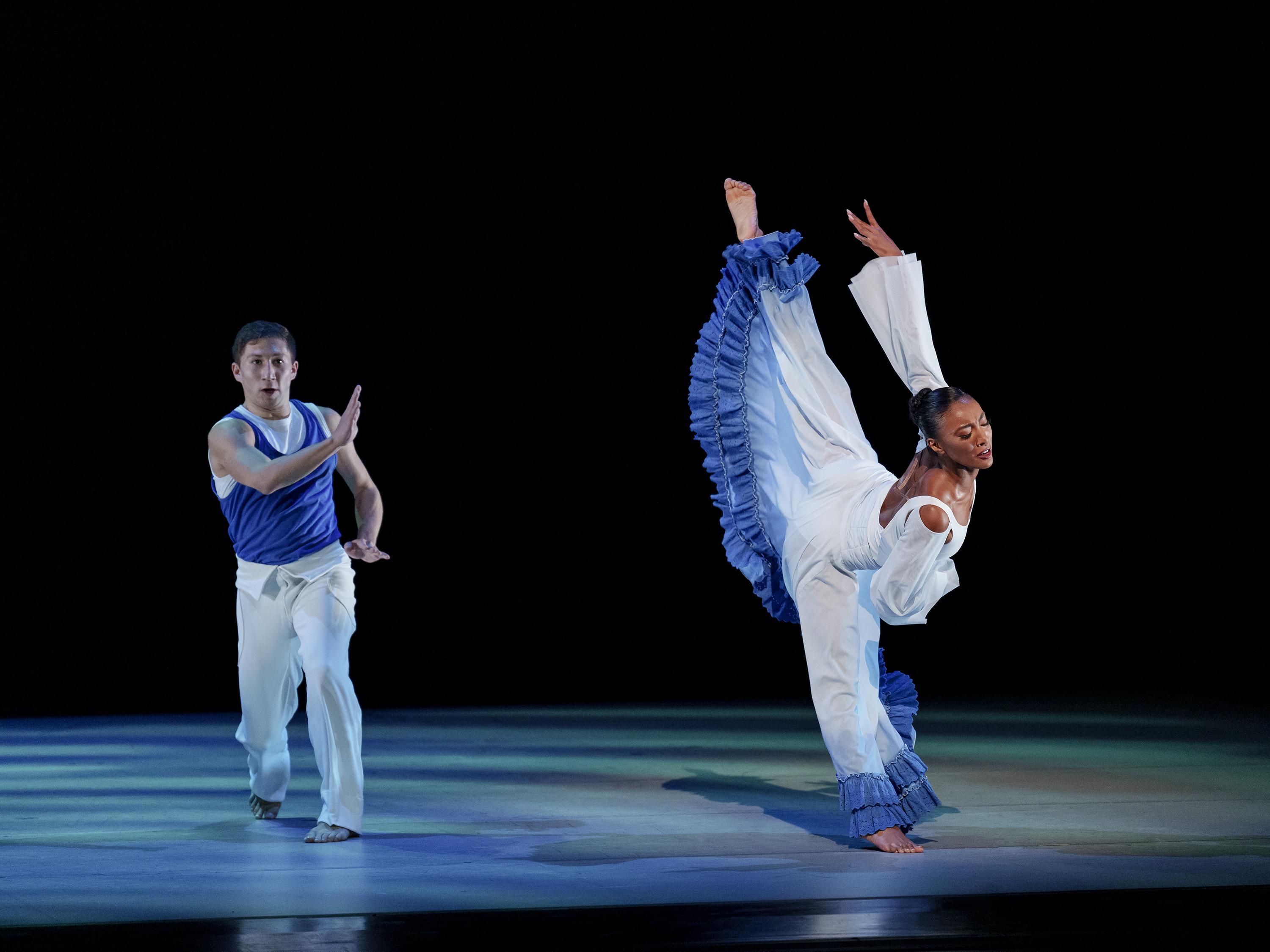 A man lunges forward next to a woman kicking one leg behind her