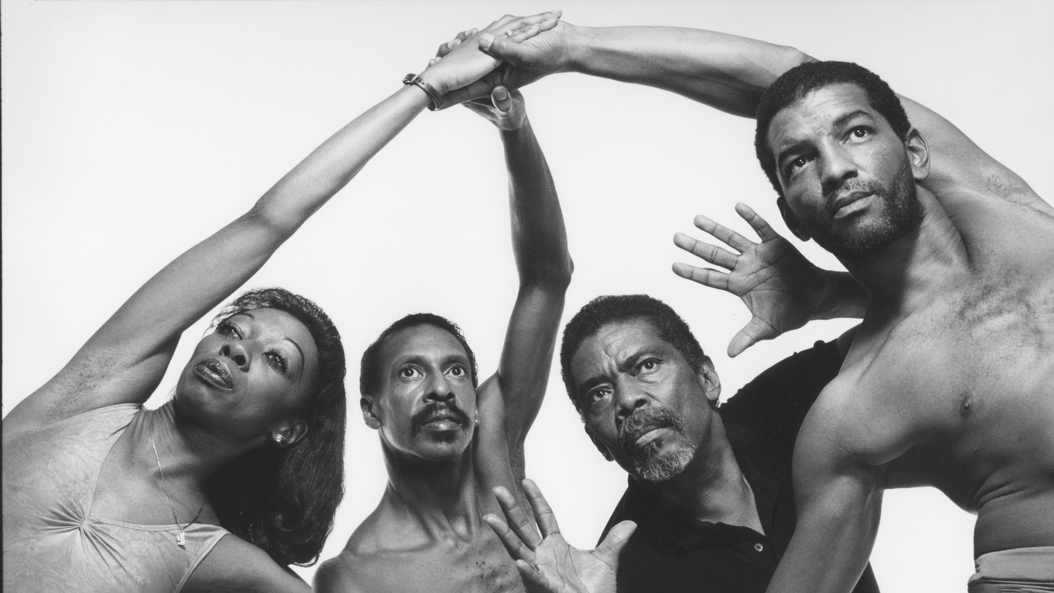 Alvin Ailey, center, poses with three dancers.